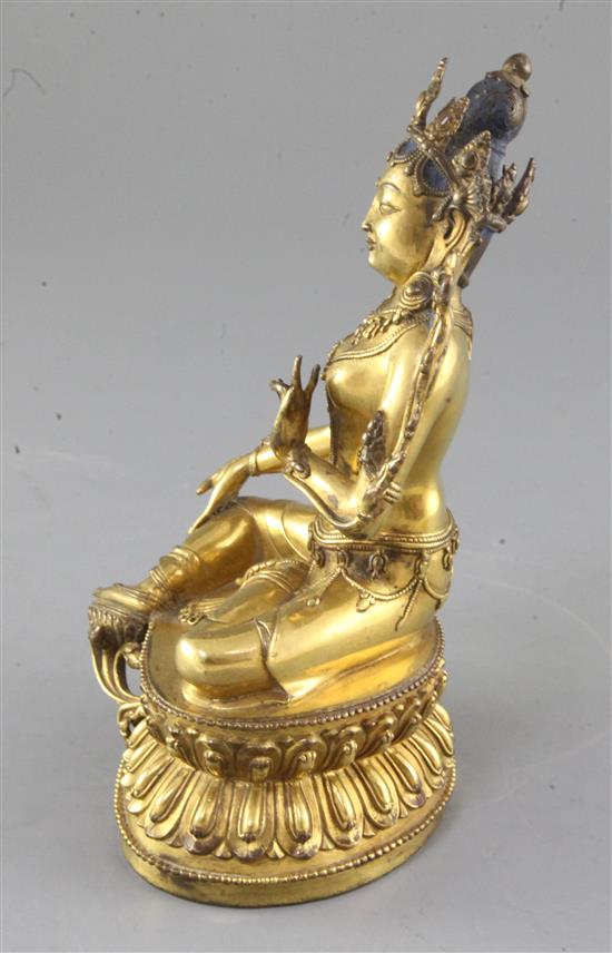 A gilt Tibetan gilt bronze seated figure of Green Tara, 18th century, height 21.5cm